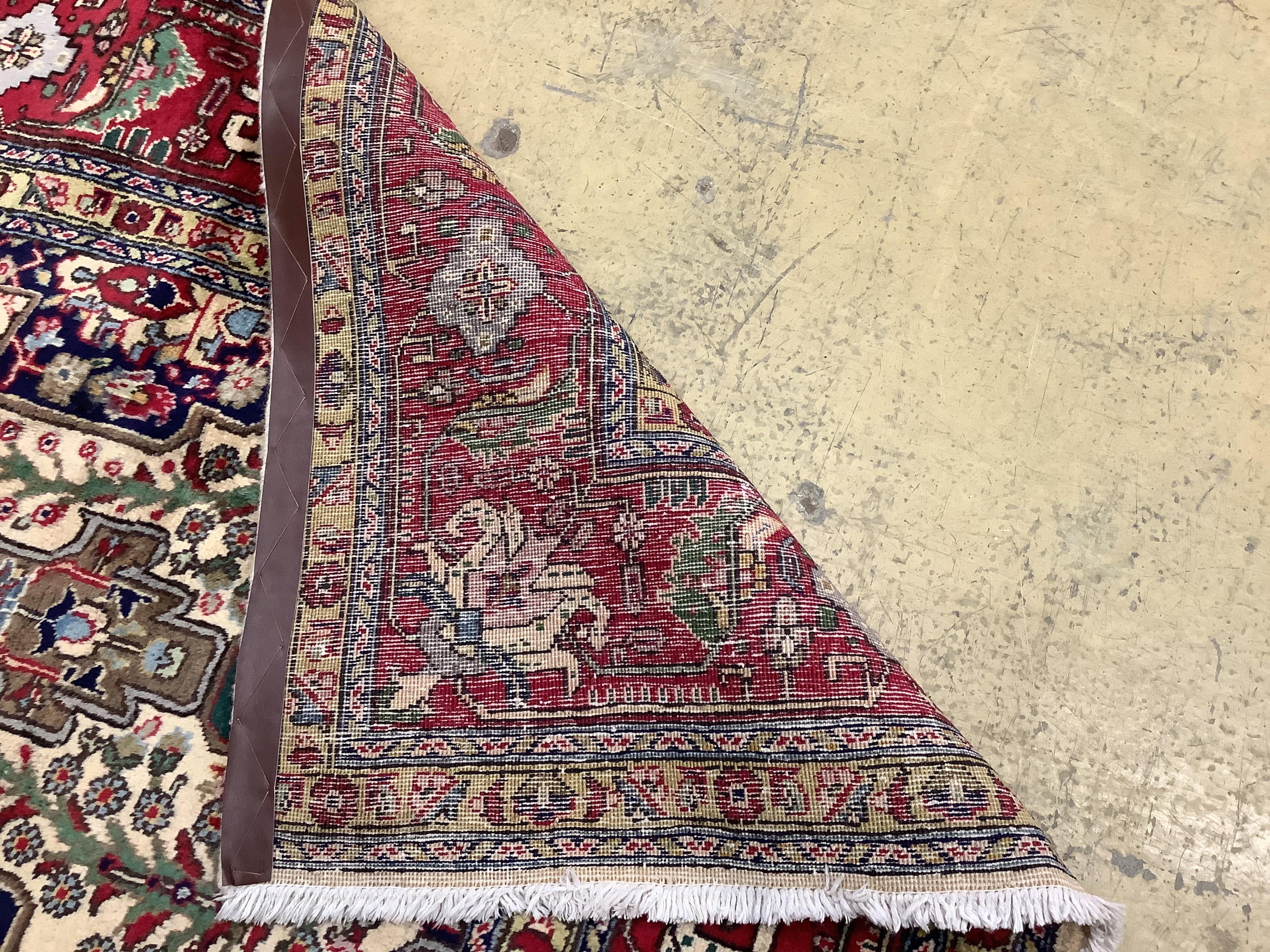 A Tabriz ivory ground carpet, 304 x 204cm